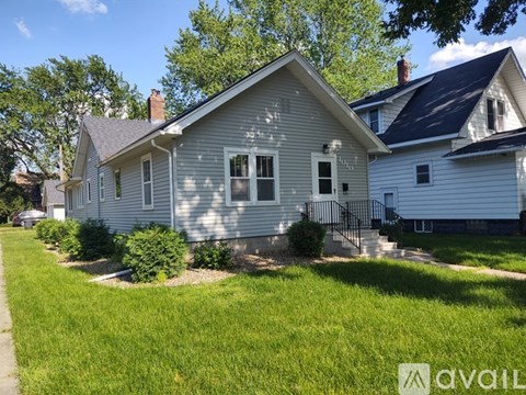A house with a well-kept lawn in front of it.