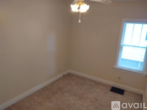 A room with a ceiling fan and a window.