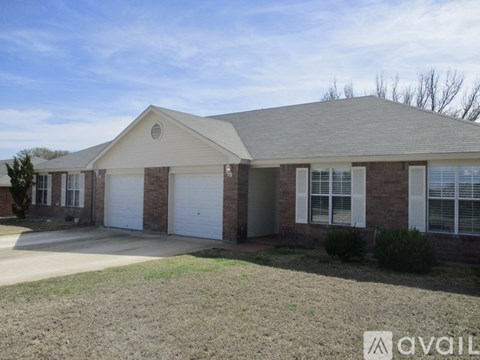 A two-story house with a garage and a driveway.