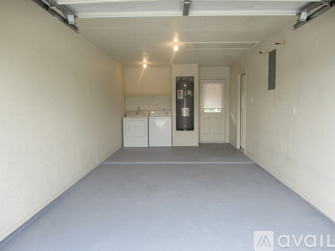 A spacious room with a washing machine and dryer in it.