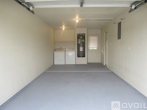 A spacious room with a washing machine and dryer in it.