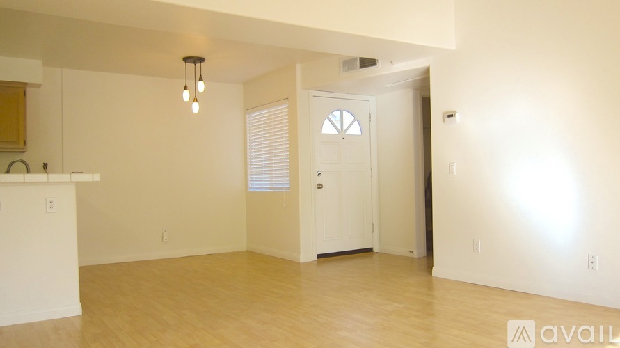 A room with a white door and a light on the ceiling.