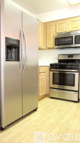A kitchen with a stainless steel refrigerator and oven.