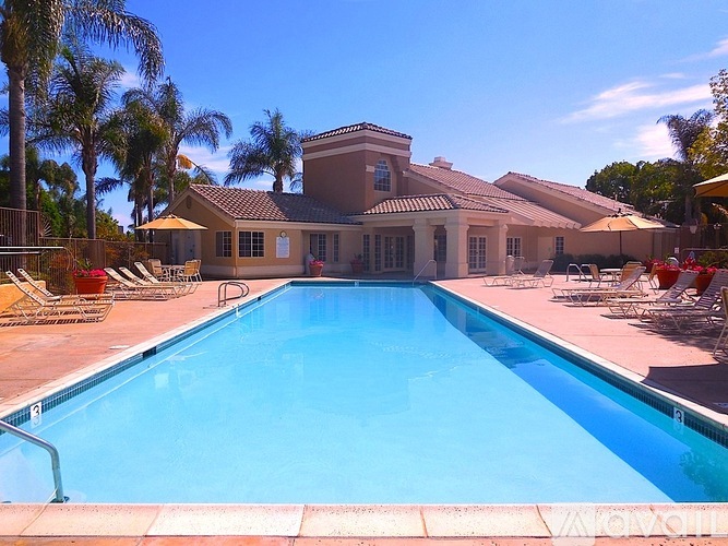 A large swimming pool in front of a house.