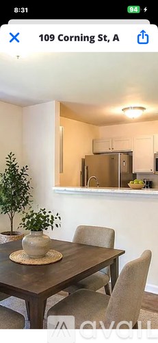 A dining room with a table set for two.