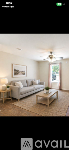 A living room with a grey sofa and a coffee table.