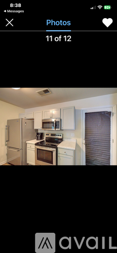 A kitchen with white cabinets and appliances.