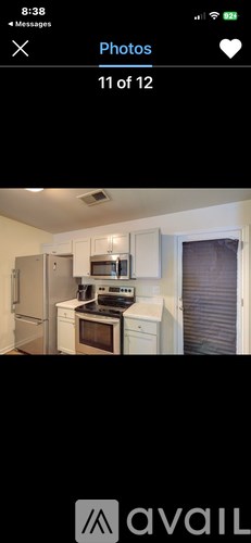 A kitchen with white cabinets and appliances.