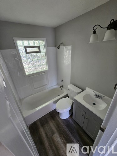 A bathroom with a toilet, sink, and bathtub.