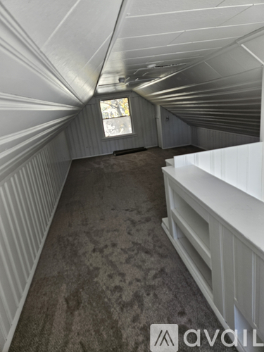 A long, narrow hallway with a window at the end.