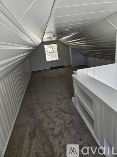 A long, narrow hallway with a window at the end.