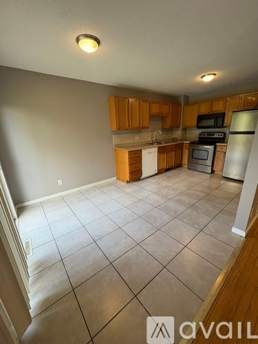 A kitchen with wooden cabinets and a white refrigerator.