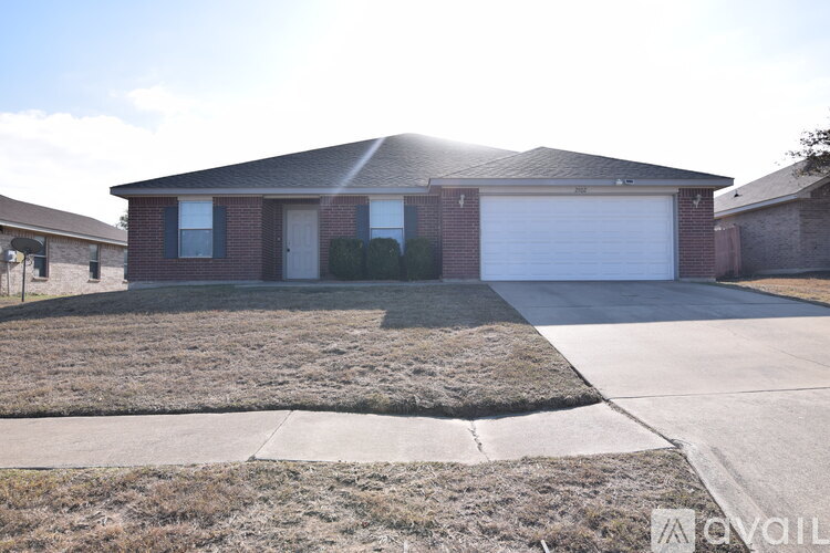 A house with a garage door is for sale.