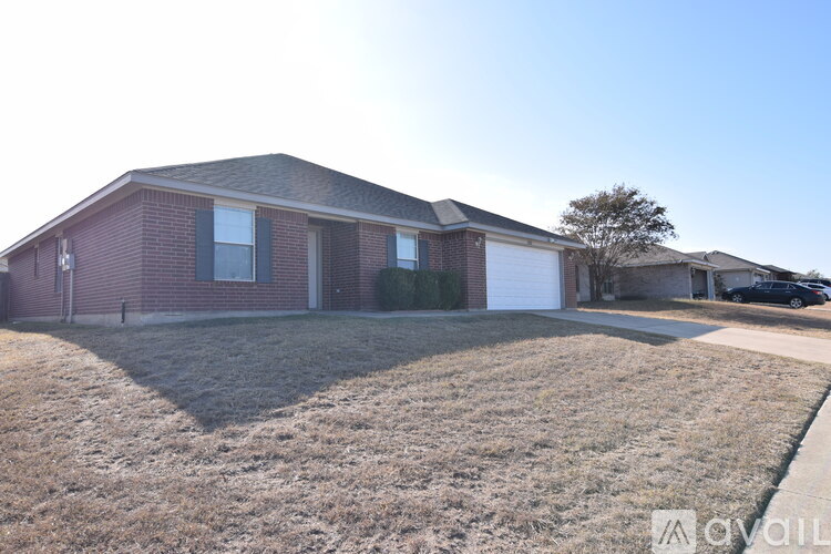 A house with a brown roof and a white garage door is for sale.