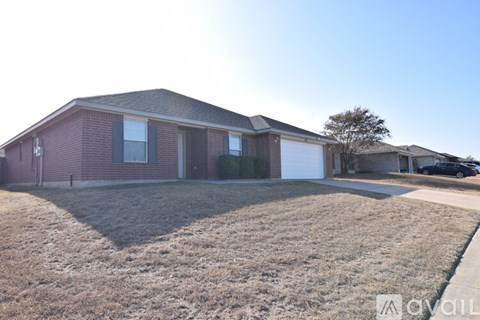A house with a brown roof and a white garage door is for sale.