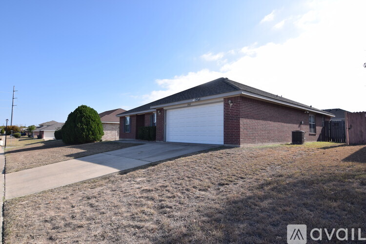 A house with a garage and a driveway in front.