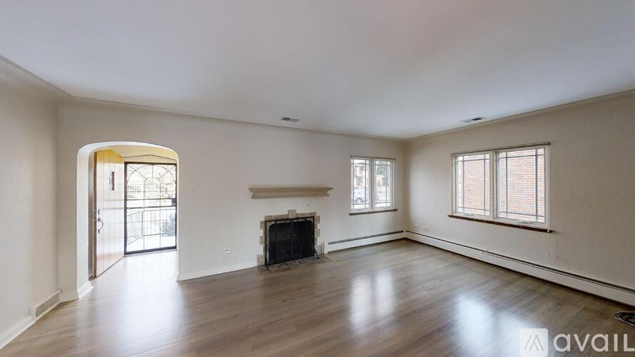 A spacious living room with a fireplace and sliding glass doors.