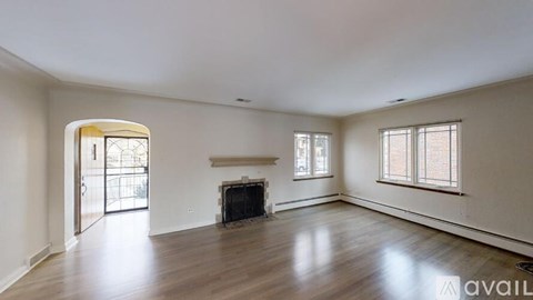 A spacious living room with a fireplace and sliding glass doors.