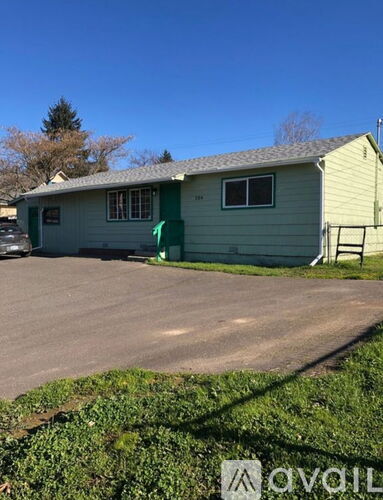 A house with a green lawn in front.