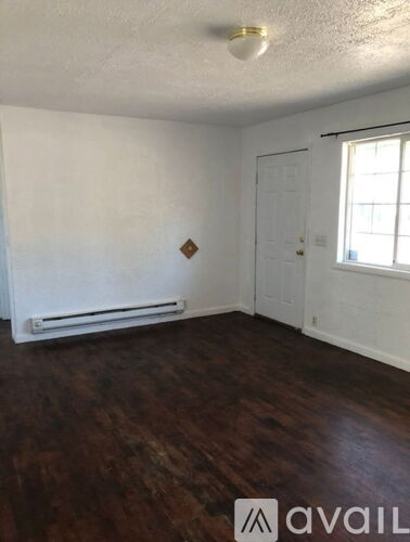 A room with wooden floors and white walls.