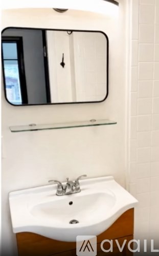 A bathroom with a sink and mirror.