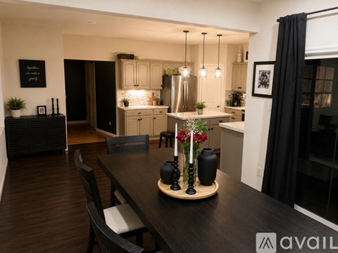 A modern dining room with a wooden table and chairs.
