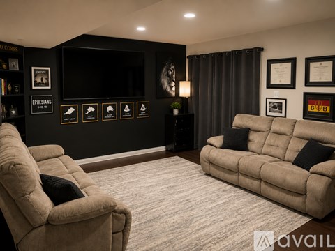 A living room with a large couch and a chair.