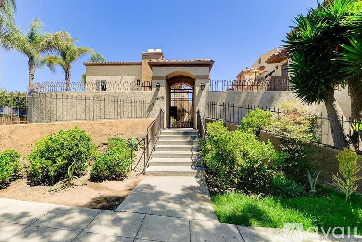 A house with a staircase leading to the front door.