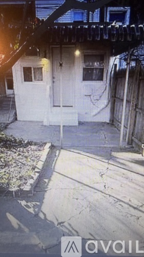 A white door is in the center of a concrete walkway.