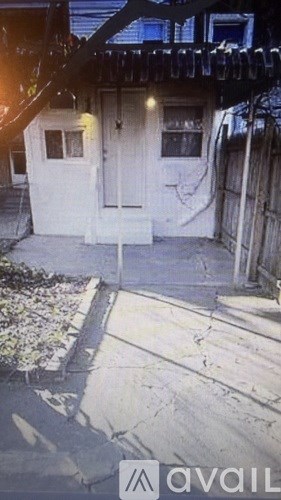 A white door is in the center of a concrete walkway.