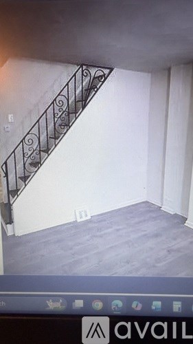 A staircase with a metal railing is in the image.