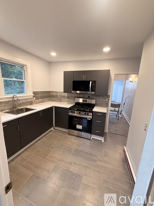 A kitchen with a sink, stove, and oven.