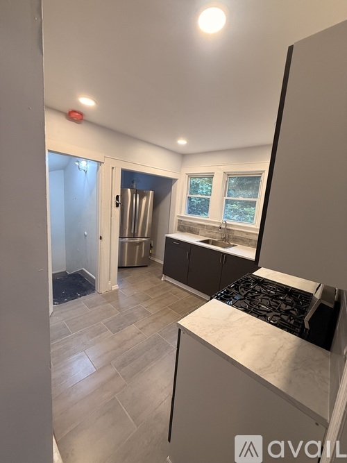 A kitchen with a sink and a window.