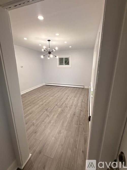 A room with wooden flooring and a ceiling fan.