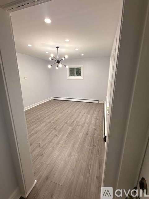 A room with wooden flooring and a ceiling fan.