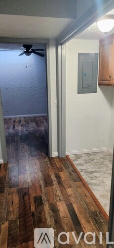 A room with a wooden floor and a ceiling fan.
