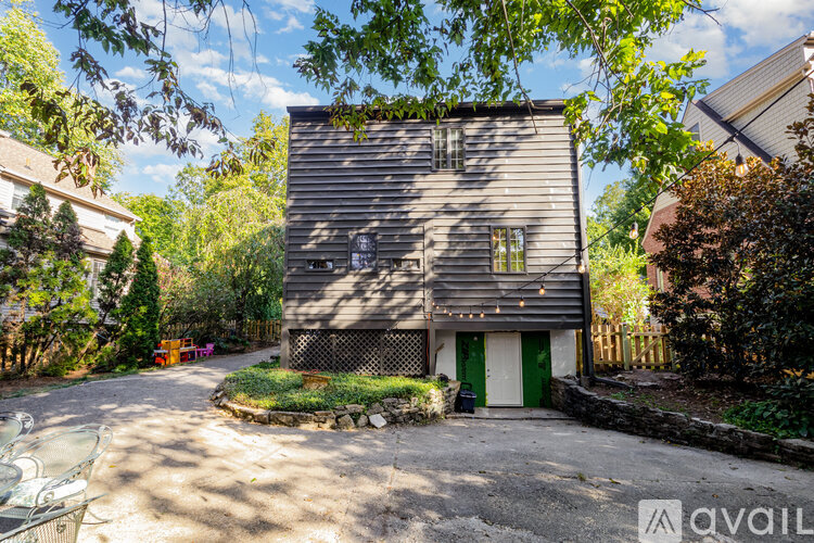 A house with a gravel driveway and a green door.