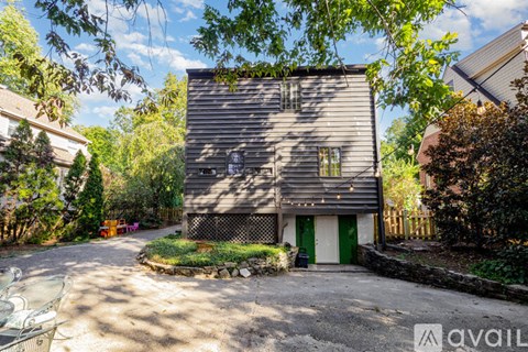 A house with a gravel driveway and a green door.