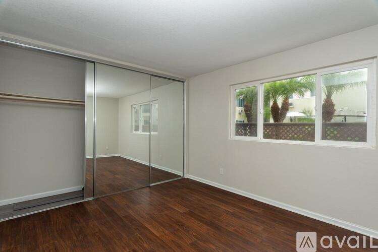A room with wooden floors and a large mirrored wall.