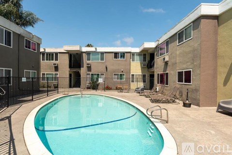 A swimming pool in front of apartment buildings.