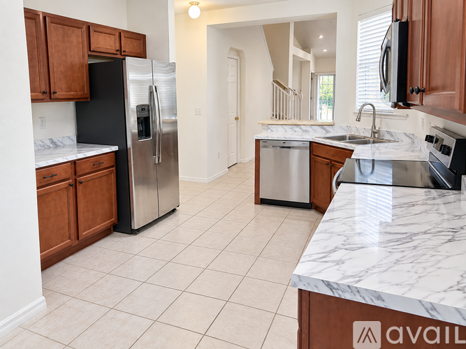 A kitchen with a refrigerator, dishwasher, and microwave.