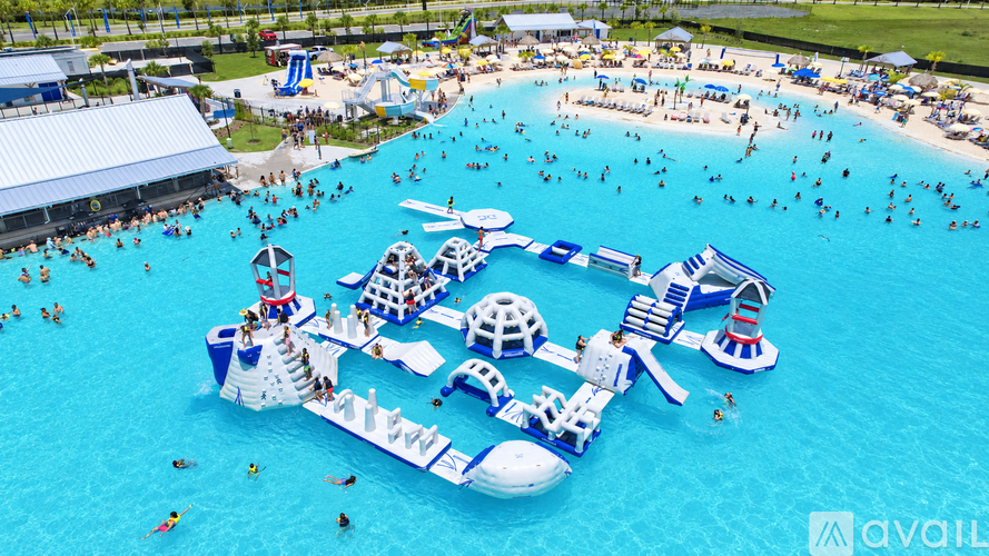 A large inflatable water park with a slide and a pool.