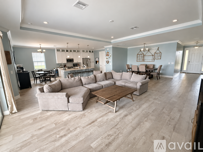 A spacious living room with a large sectional sofa and a coffee table.