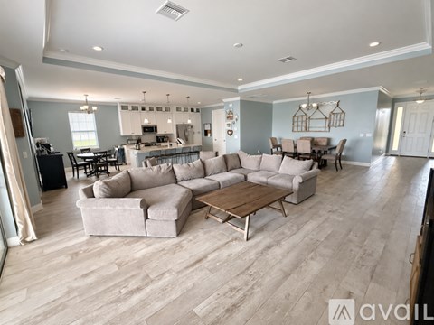 A spacious living room with a large sectional sofa and a coffee table.
