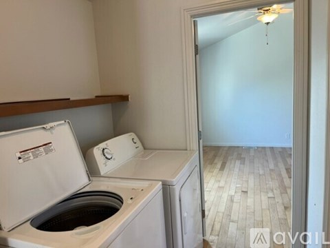 A small laundry room with a washer and dryer.