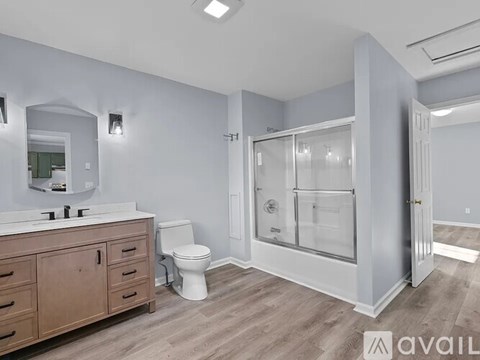 A bathroom with a toilet, sink, and shower.