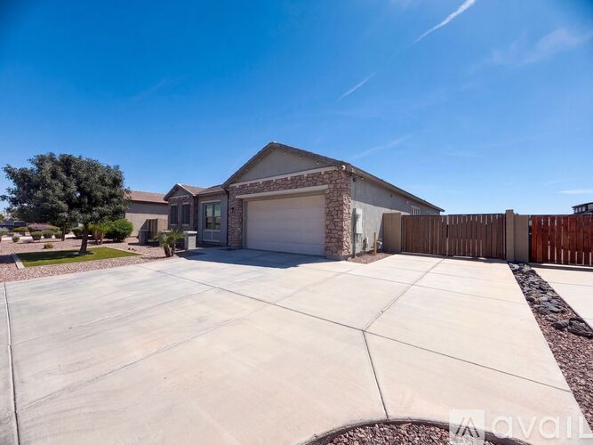 A house with a garage and a driveway is available for sale.