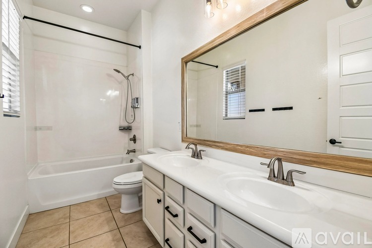 A bathroom with a white sink, toilet, and bathtub.