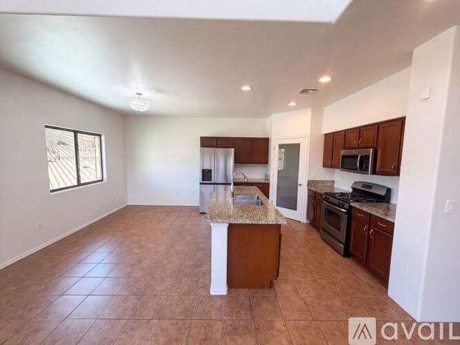 A kitchen with brown cabinets and a white island.