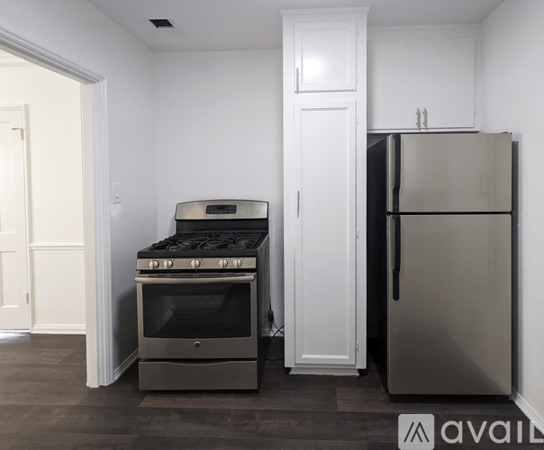 A kitchen with a stove, oven, and refrigerator.